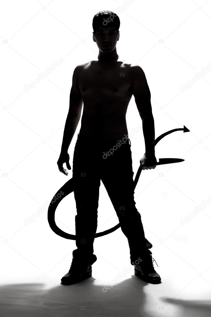 silhouette of a man holding knife