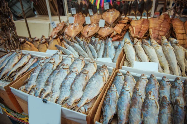 Dried fishes hanged with the ropes in a shop of fish market — Stock Photo, Image