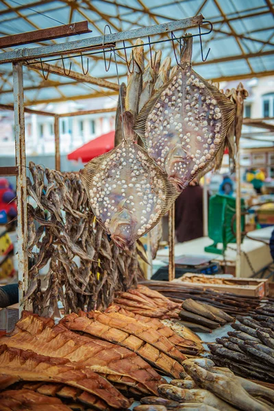 Dried fishes hanged with the ropes in a shop of fish market — Stock Photo, Image