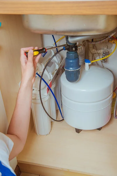 Plumber installs a water filter. water filter.