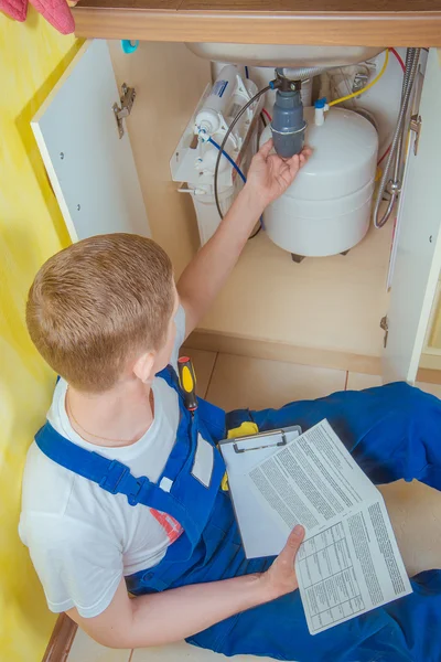 Plumber installs a water filter. water filter. Stock Picture