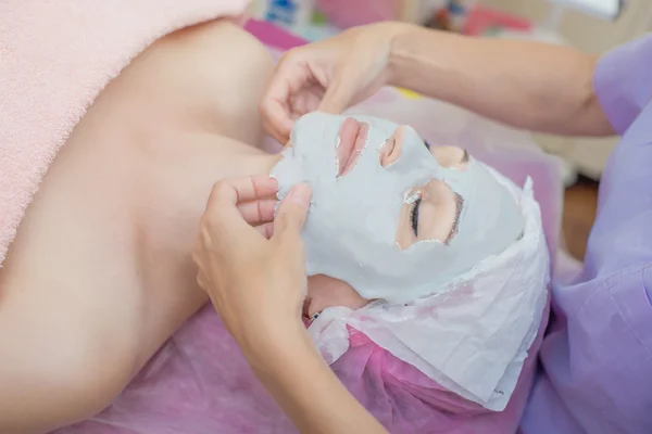 Woman in a beauty salon. cosmetology, facial mask