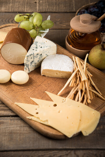 Assorted cheeses in various shapes and sizes