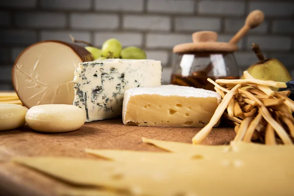 Assorted cheeses in various shapes and sizes — Stock Photo, Image