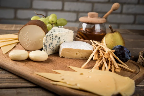 Assorted cheeses in various shapes and sizes — Stock Photo, Image