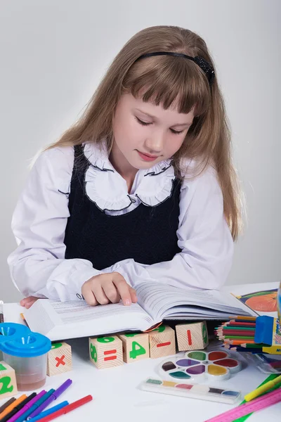 Schoolgirl reading a book — Stock Photo, Image