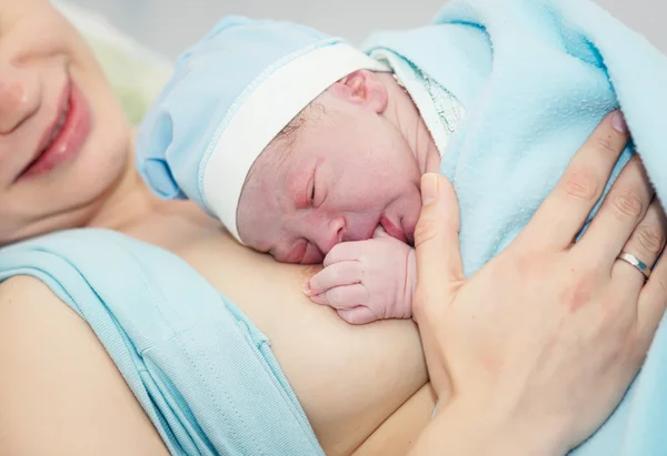 Young beautiful woman with a newborn — Stok fotoğraf