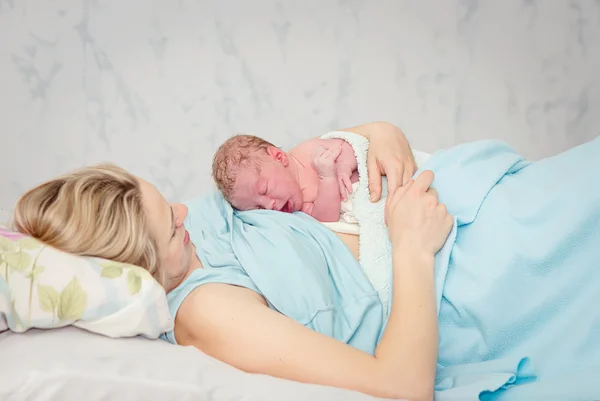 Young beautiful woman with a newborn — Stock Photo, Image