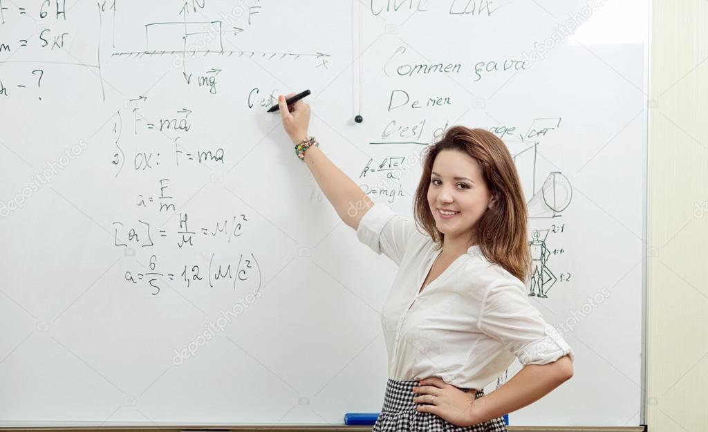 student answers in the classroom at the blackboard