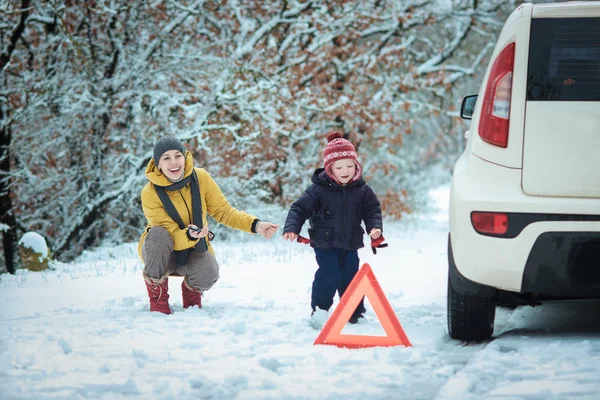 Woman with a child on the winter road Stock Image
