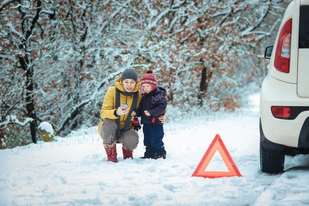 woman with a child on the winter road