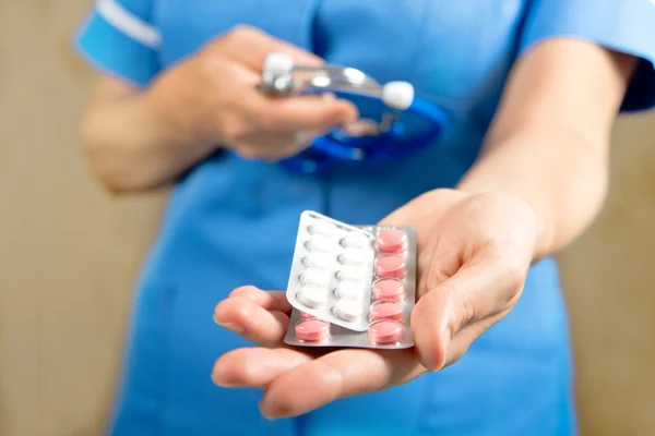 Médico con pastillas en la mano — Foto de Stock