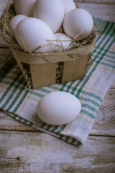 Chicken eggs on a wooden background — Stock Photo, Image