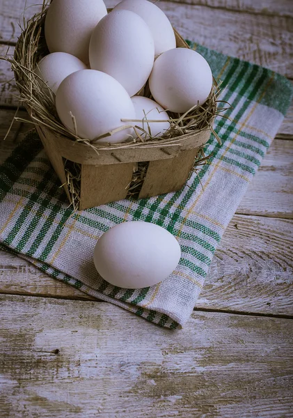 Chicken eggs on a wooden background — Stock Photo, Image