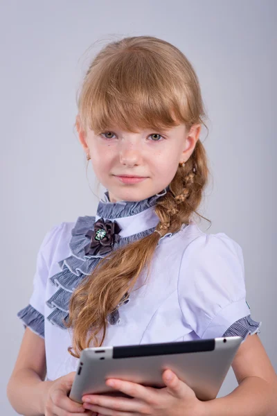 Cute schoolgirl with a laptop — Stock Photo, Image