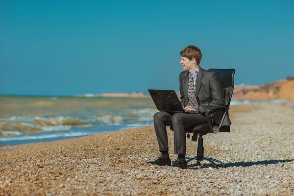 Man with laptop, sitting outdoors ストックフォト