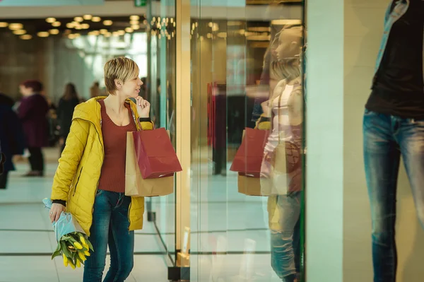 Girl with purchases. Woman with packages from the store. Stock Picture