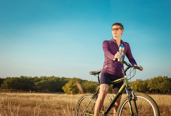 Cyclists riding on a dirt road — Stok fotoğraf