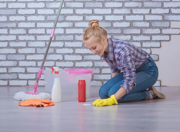 Girl washes the floors