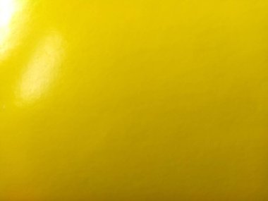 Güzel sarı bir arka plan. Yakın plan bir kağıt parçası. Saf neşeli bir renk. Sarının canlı tonu.