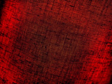 Kumaştan yapılmış kırmızı soyut arkaplan. Makro görüntü. Tap renginde çukurlar örüyorlar, siyah gölgeler ve vignettlerle. Noel için arka plan, Yeni Yıl, Sevgililer Günü