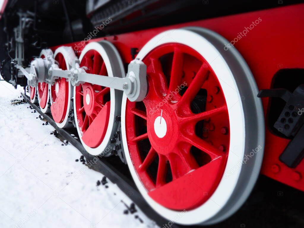 retro train. Locomotive of the 19th early 20th century with a steam engine. Vintage style. Black train with red wheels. Metal cast iron parts. Levers, engines, fences, boilers, pipes of the train.