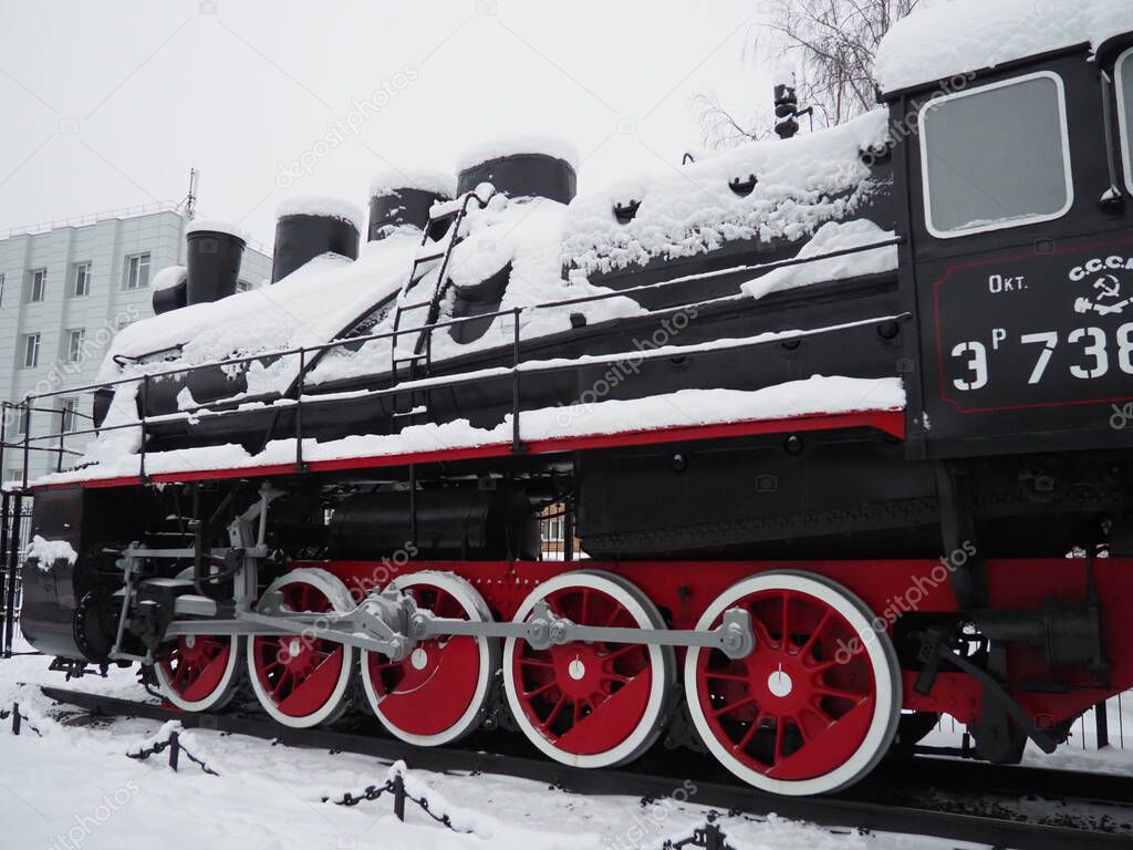 retro train. Locomotive of the 19th early 20th century with a steam engine. Vintage style. Black train with red wheels. Metal cast iron parts. Levers, engines, fences, boilers, pipes of the train.