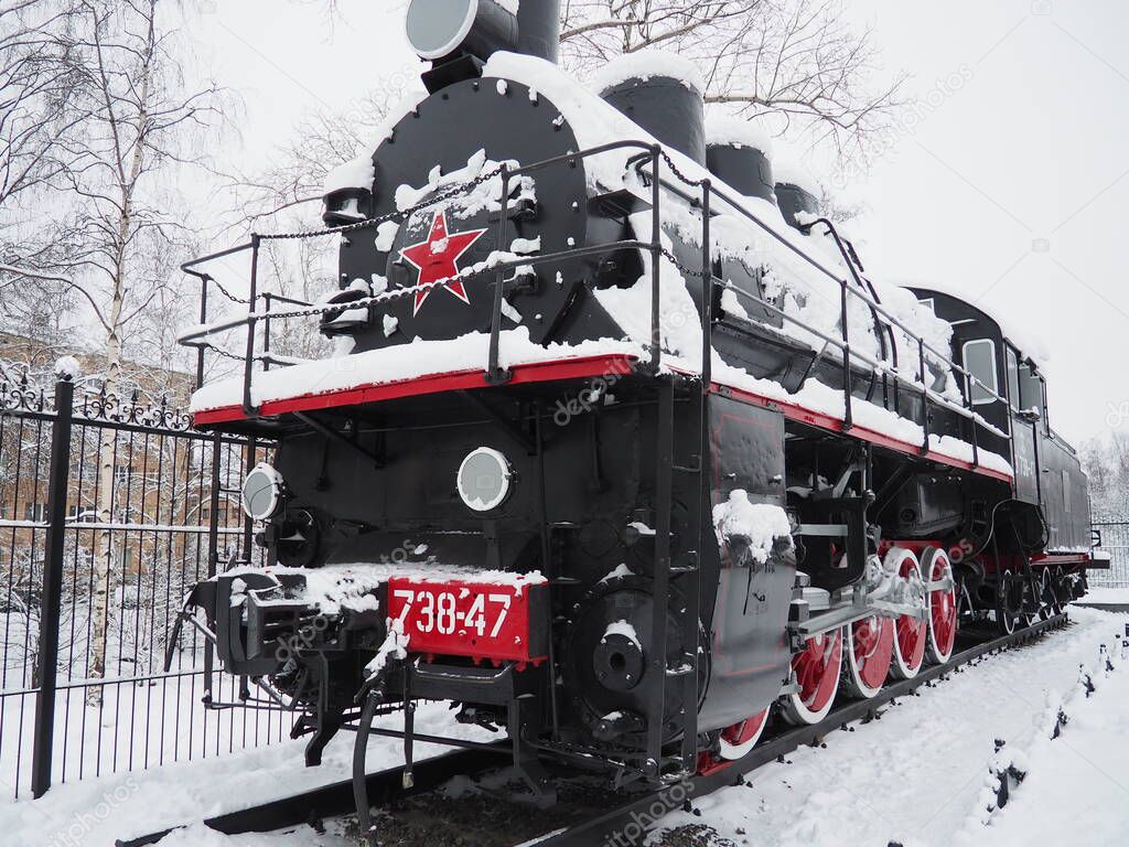 retro train. Locomotive of the 19th early 20th century with a steam engine. Vintage style. Black train with red wheels. Metal cast iron parts. Levers, engines, fences, boilers, pipes of the train.