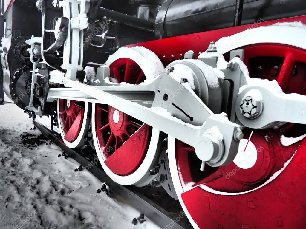 retro train. Locomotive of the 19th early 20th century with a steam engine. Vintage style. Black train with red wheels. Metal cast iron parts. Levers, engines, fences, boilers, pipes of the train.