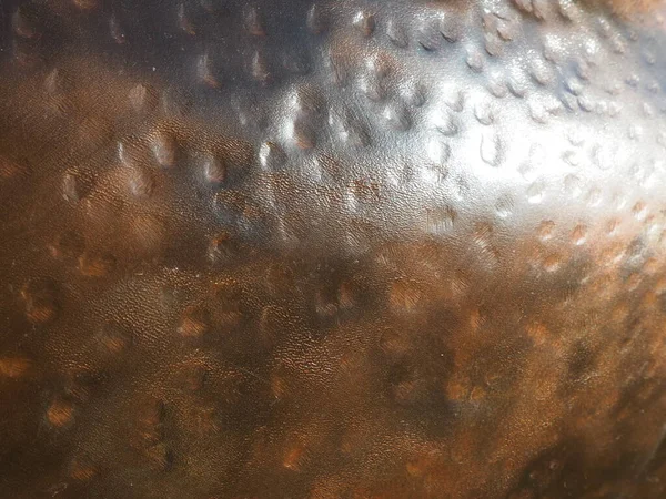 Metal bronze textured plate. Bronze or copper polished surface with dents, scratches and indentations. Metal texture.