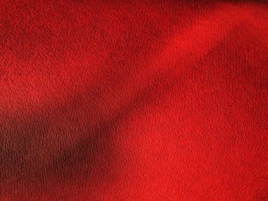 Soyut kırmızı arkaplan ve doku. Işık ve renk eğimine sahip kağıt yüzeyine yakın çekim. Yan ışıklandırma. Parlak kırmızı arkaplan.