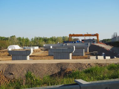 Sremska Raca, 25 Nisan 2021. Sava Nehri üzerinde bir köprü inşa edilmesi, vinç operasyonu, kirişler ve beton yapılar. Altyapı projesi Belgrad - Saraybosna otomotiv rotası. Yol inşaatı.