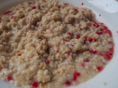 Organic Granola Cereal with oats, powdered sugar and dry raspberries. Healthy muesli spiced with water. Low-calorie diet. Anti-diabetes.