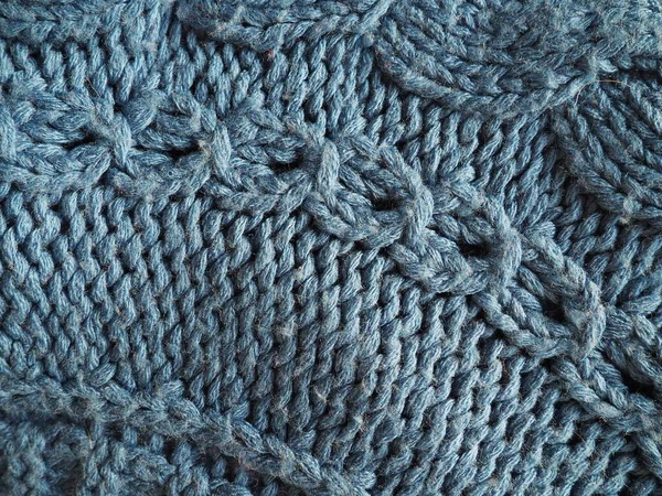 꼬챙이나 크로셰로 아크릴 실로 만든 뜨개 질 무늬. 얼굴 과 안 고리. 수작업이죠. 블루 실. 스웨터 나 점프 의 요소 — 스톡 사진