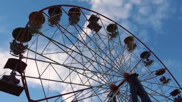 Petrozavodsk, Russia 26 giugno 2021. La ruota panoramica si muove contro un cielo blu con nuvole bianche. La rotazione dell'attrazione di intrattenimento in senso orario. Ruota panoramica nel parco cittadino — Video Stock