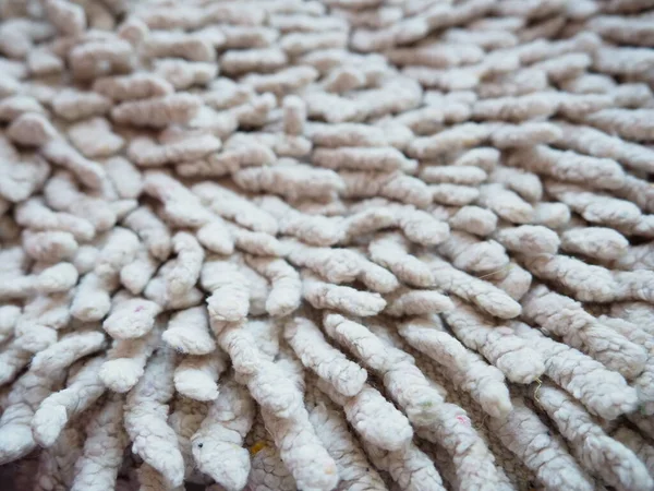 Close-up of a long pile on the carpet of beige or gray. A non-slip bath mat or toilet. Long carpet. Ticks in carpets.