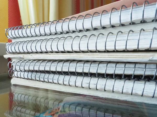A stack of spring notebooks. Thick notebooks or notebooks placed on top of each other. Office items for records, keeping your diary, keeping accounting and business. Educational supplies.