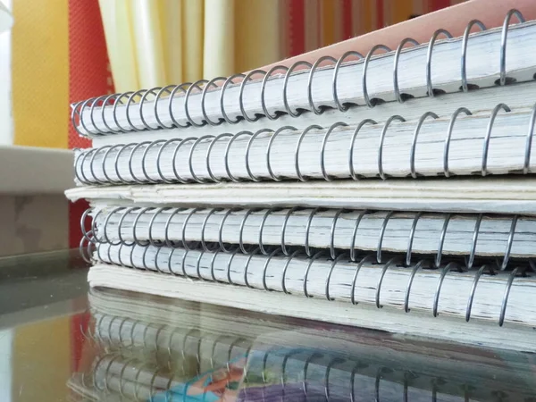 A stack of spring notebooks. Thick notebooks or notebooks placed on top of each other. Office items for records, keeping your diary, keeping accounting and business. Educational supplies.