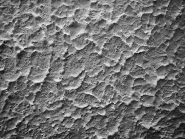 Plaster, finishing layer formed by hardened building cement mortar. Hand-plastered walls.a with the effect of waves, elevations and irregularities. Monochrome white-black abstract background.