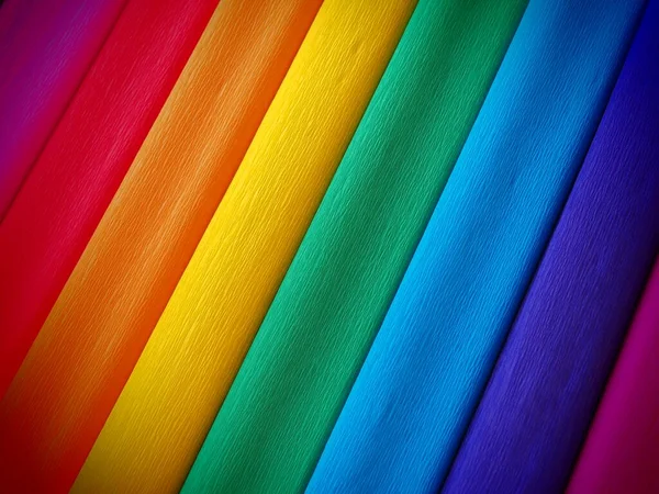 Bandera del orgullo por Gilbert Baker. Símbolo de la comunidad LGBTI en general. El papel crepé está disponible en rosa, rojo, naranja, amarillo, crepé, azul, morado y magenta. Fondo colorido para los eventos del Orgullo — Foto de Stock