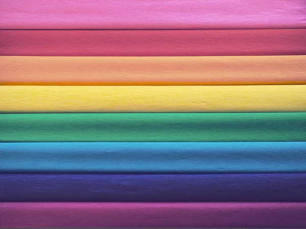 Bandera del orgullo por Gilbert Baker. Símbolo de la comunidad LGBTI en general. El papel crepé está disponible en rosa, rojo, naranja, amarillo, crepé, azul, morado y magenta. Fondo colorido para los eventos del Orgullo — Foto de Stock