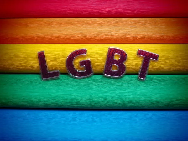 Afkorting LGBT, brief tekst. Paarse LGBT letters op de achtergrond van de regenboogvlag. Donker vignet. Een Rainbow Flag, de Pride Flag. LGBTQ-gemeenschapssymbool. — Stockfoto