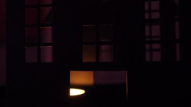 Karanlık gölgeler korkunç bir kalede dans ediyor mum ışığı pencerelerden geçerken. Ürkütücü atmosfer, Cadılar Bayramı gecesinde korku ve gerilim yaratıyor..