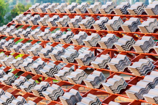 Roof under construction with stacks of roof tiles for home build — Stock Photo, Image