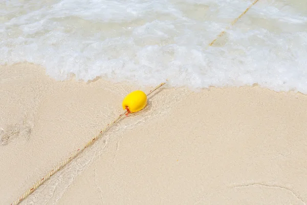 Yellow buoy on the beach — Stock Photo, Image