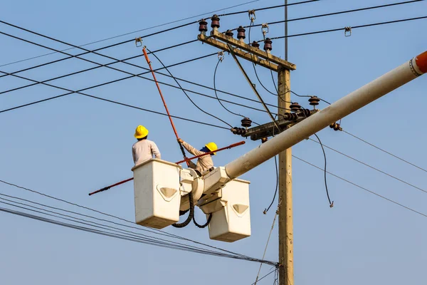 Electrician worker at climbing work on high voltage post — Stock Photo, Image