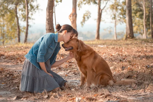 Beautiful woman with a cute golden retriever dog — Stock Photo, Image