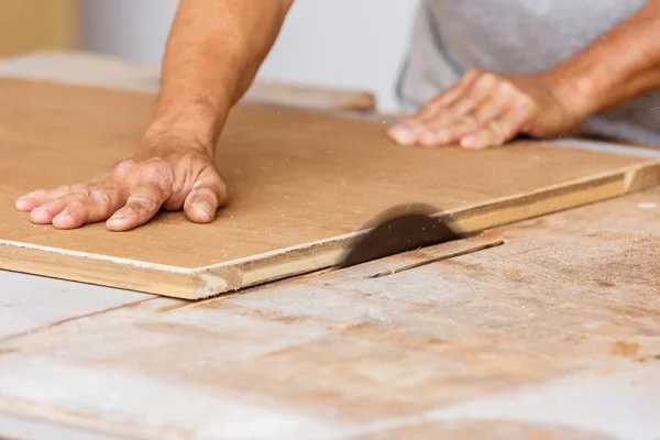 Carpenter use saw cut wood for make new furniture — Stock Photo, Image