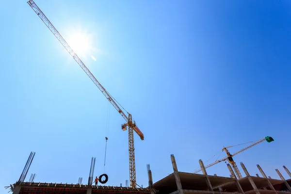 Mavi gökyüzünün altında vinç ve inşaat site bina — Stok fotoğraf