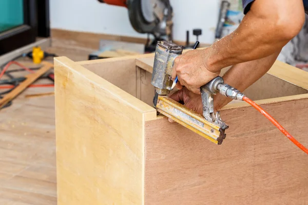 Carpenter use air-gun — Stock Image Carpenter use air-gun Stock Photo